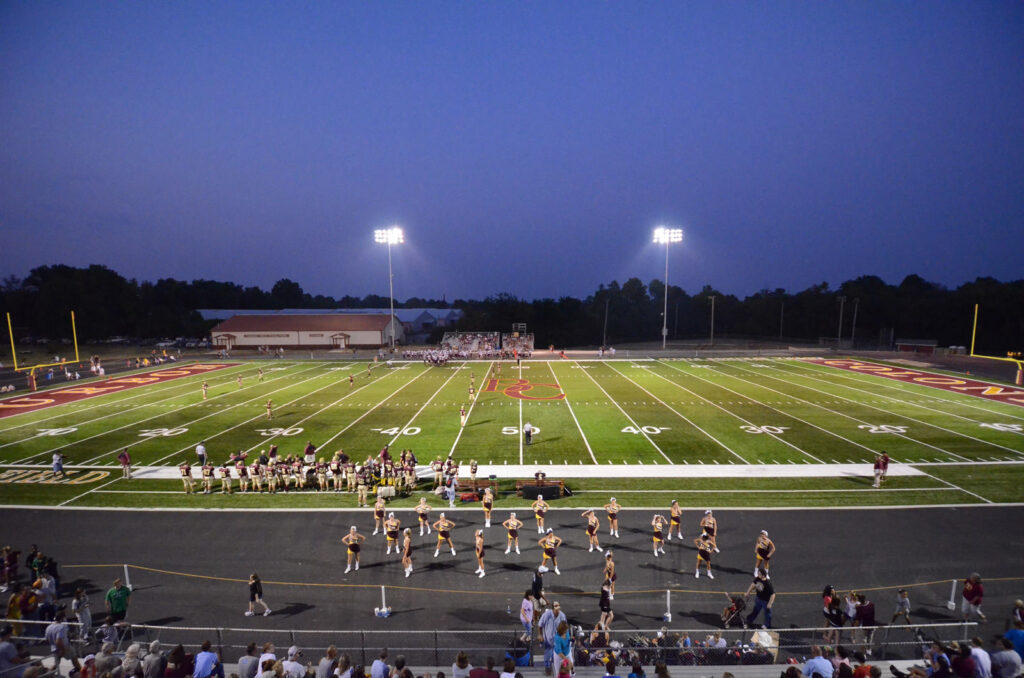 high school football game view from stands|high school track and field|high school football game athletes playing|high school dance team performance football field|high school football field and goal post||||||||