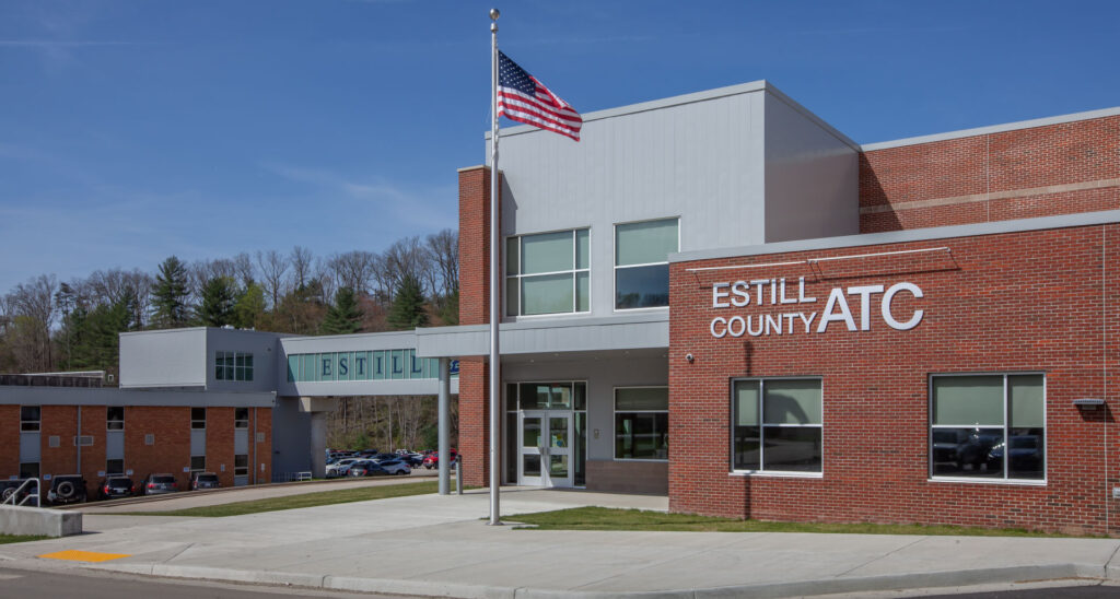 school building exterior view|school building exterior view|students walking through hallway|student walking down stairs in school|long hallway with large windows|long hallway with large windows|students learning healthcare|students working together in technology class|students working together in school|students working together in school|high school students learning building||||||||||||||||||||