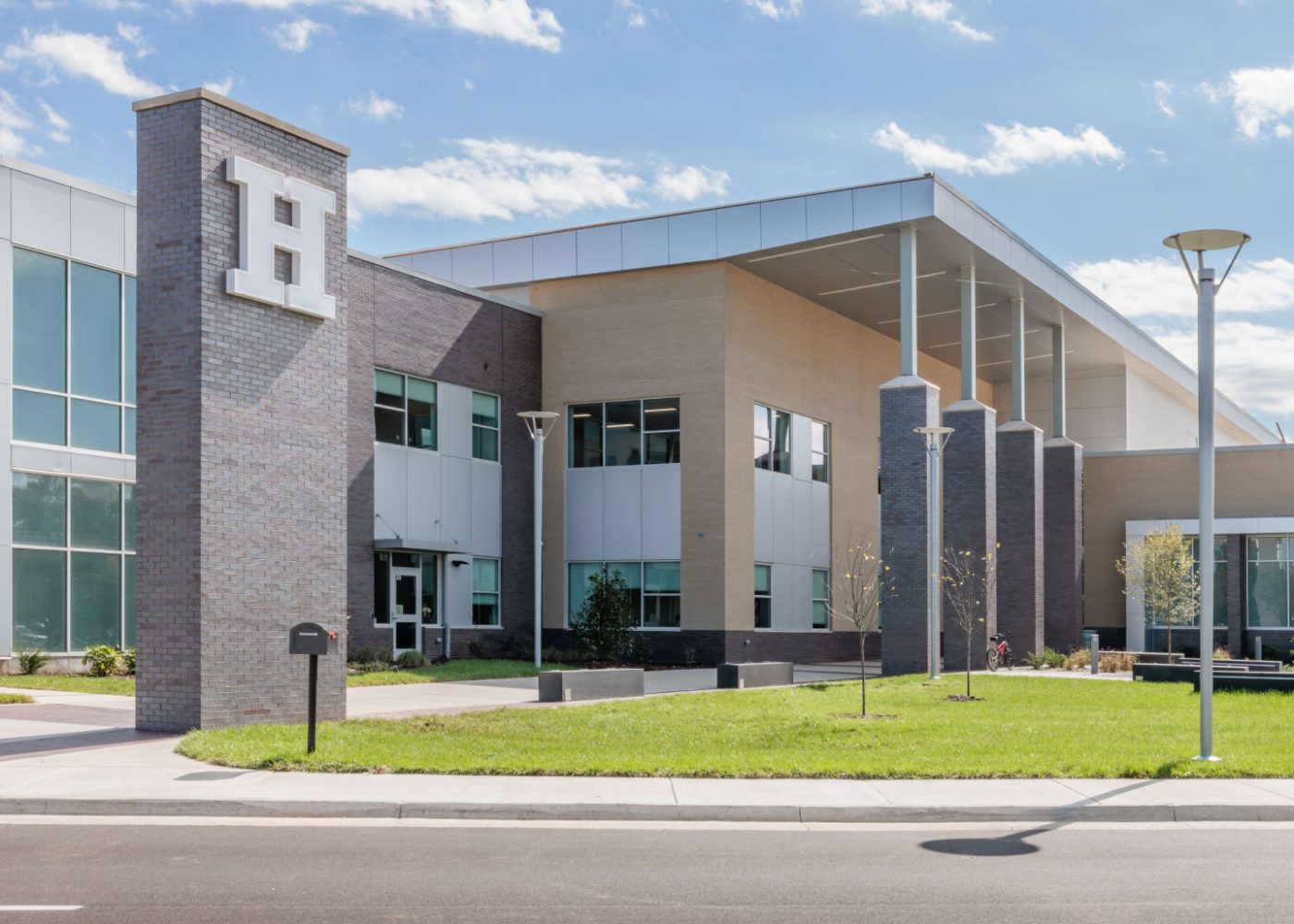 high school exterior|high school building exterior|high school students socializing in hallway|high school students learning science|high school students learning healthcare|high school building exterior|high school building exterior|social staircase in cafeteria|students socializing in cafeteria|students socializing outside|high school auditorium for performances|students reading in library|high school gymnasium|high school outdoor courtyard with ping pong tables and students||||||||||||||||||||||||||
