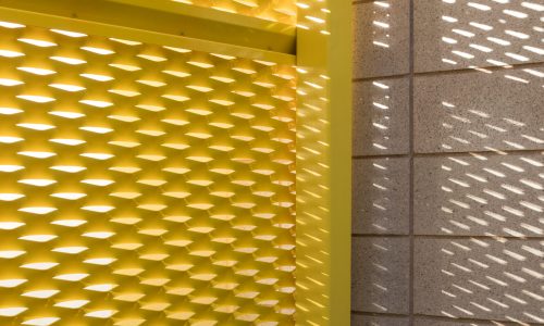 Detail view of the yellow metal mesh walls featured at Clark County Fire Station 61 in Las Vegas, NV.
