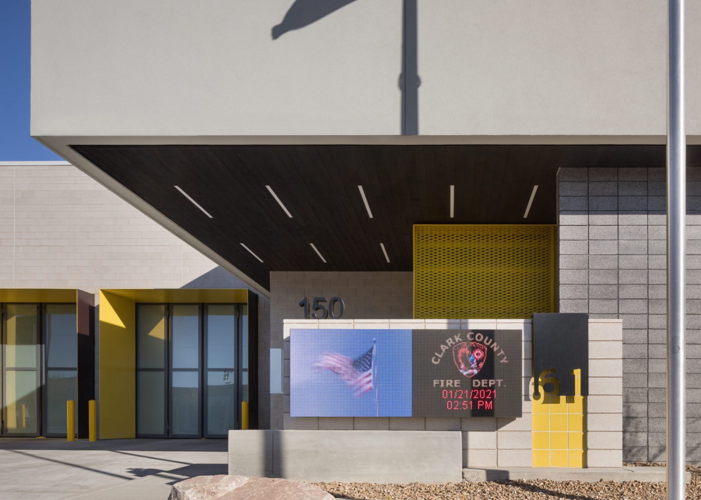 Exterior view of Clark County Fire Station 61 in Las Vegas, NV. Note the burnt wood ceiling, which also continues into the interior lobby.