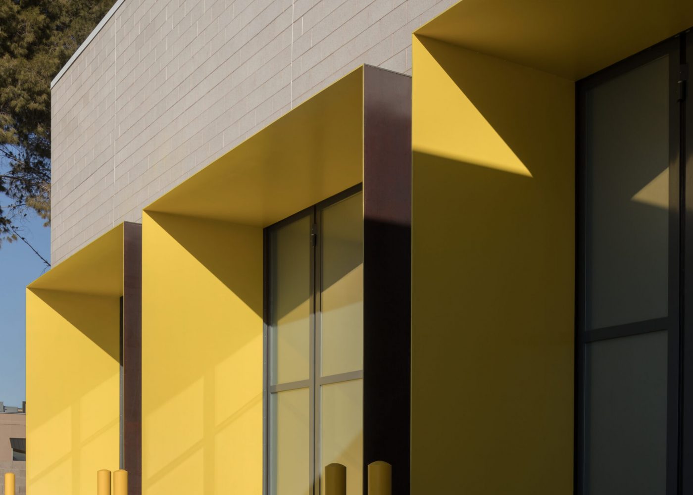 The three large apparatus bay doors at Clark County Fire Station 61 in Las Vegas, NV split in the middle and fold to provide entry and egress from the apparatus bay.