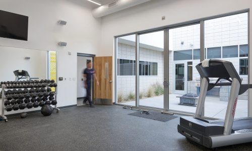 The fitness room at Clark County Fire Station 61 in Las Vegas, NV. The fitness room features sliding glass doors out to the grill area, which is also accessible via the kitchen.