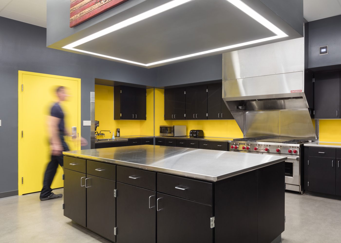 The kitchen inside Clark County Fire Station 61 in Las Vegas, NV features a large island work area and a large cooking area.