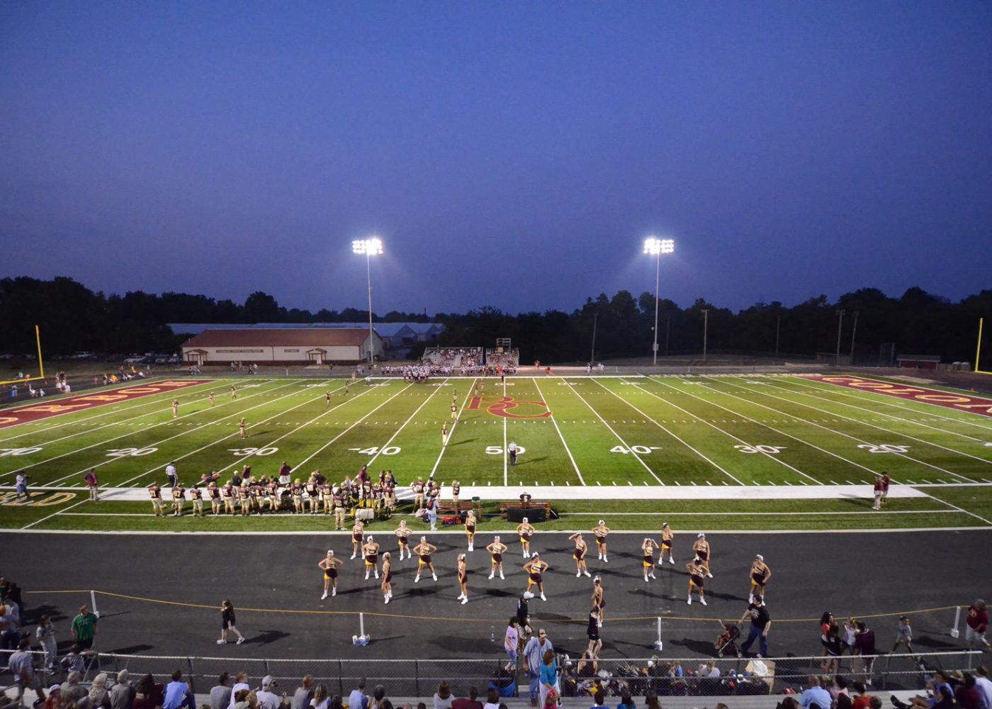 high school football game view from stands|high school track and field|high school football game athletes playing|high school dance team performance football field|high school football field and goal post||||||||