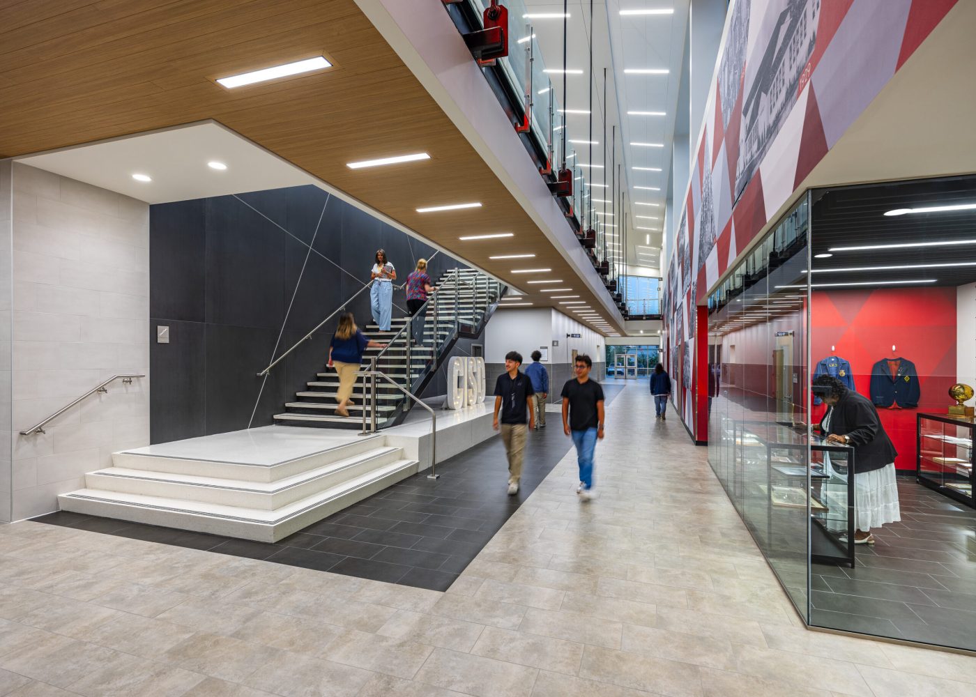 Students walking through a main corridor designed by Huckabee Architects