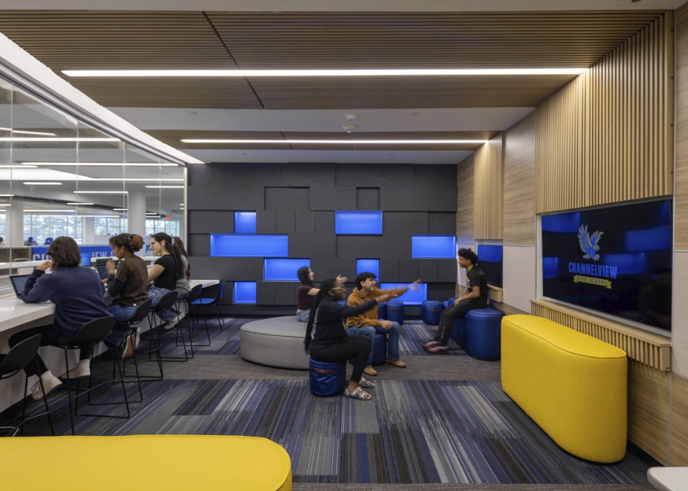 Students enjoying a high school gaming lab designed by Huckabee Architects