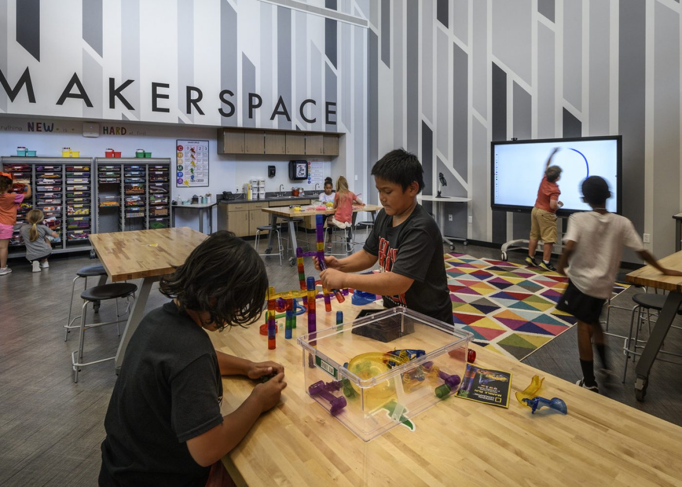 Students building in a maker space designed by Huckabee Architects